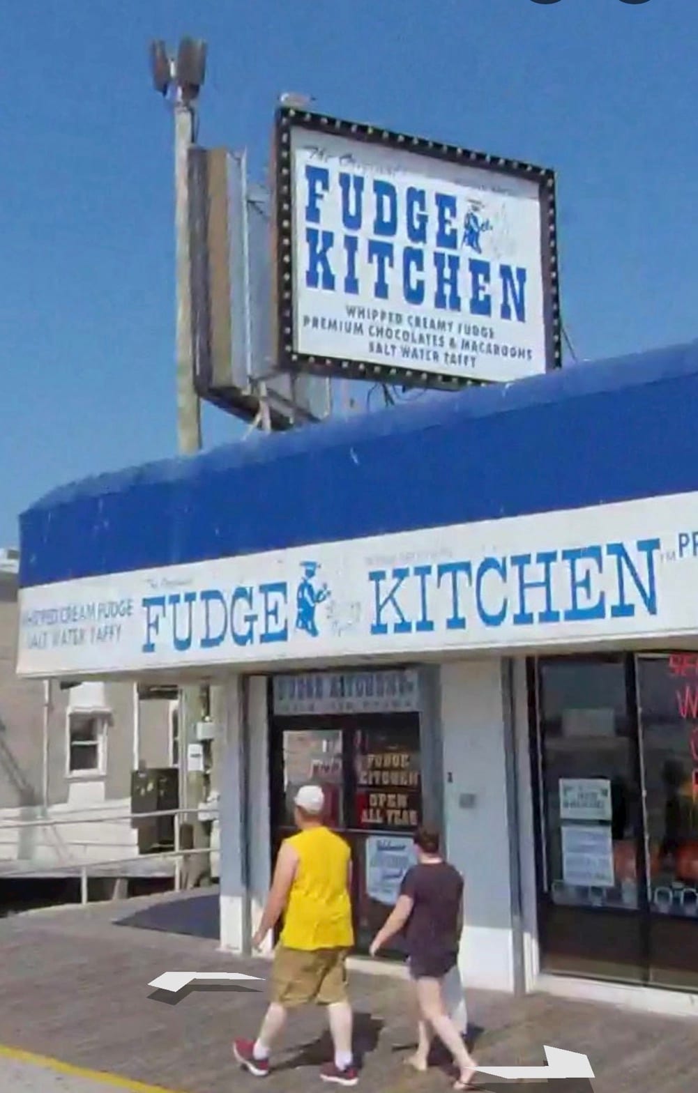 Fudge Kitchen storefront with its blue awning and sign on the boardwalk