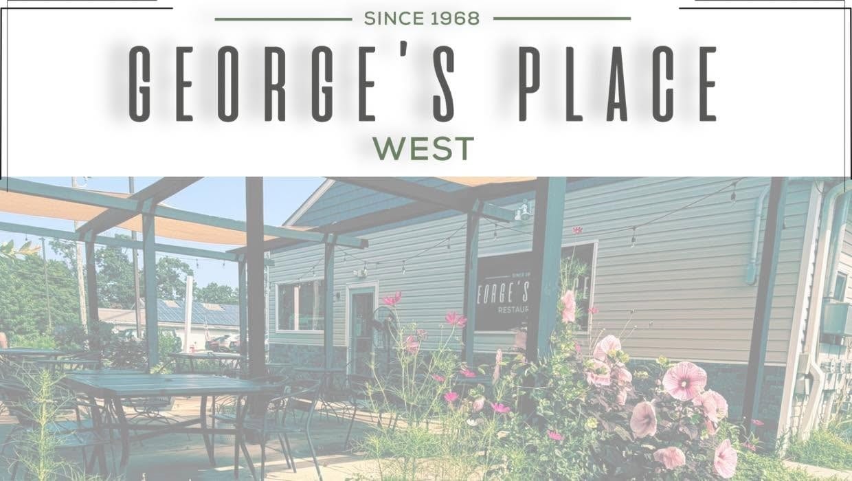 George's Place West sign above the restaurant's covered outdoor patio, with tables, string lights and pink hibiscus